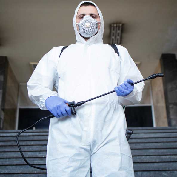 man spraying mold treatment for remediation